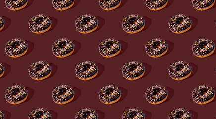 Pattern of chocolate donut on a brown background