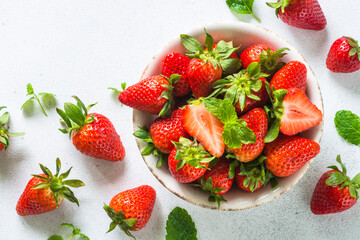 Strawberry. Fresh ripe strawberry in craft bowl at white table.