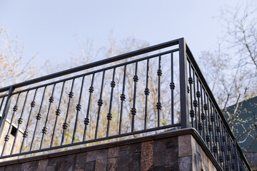 Modern metal railings and handrails in the loft style. The metal is treated with a primer and...