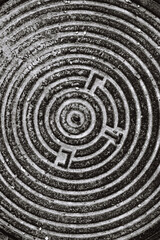 Fototapeta na wymiar Black and white circle pattern of old metal manhole texture background with tint.