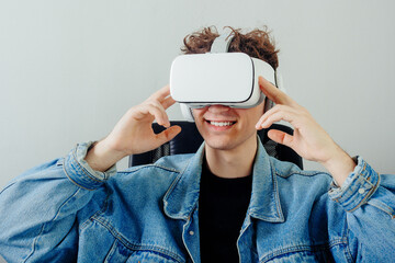 Happy handsome teenager with virtual reality equipment. VR technolohy concept.