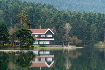 Fototapeta na wymiar Bolu Golcuk Tabiat Parki. Bolu National Park. Landmarks or touristic places of Turkey. Wooden green house by the lake. 