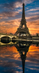 Eifel tower from river Seine with dramatic sky and reflection in Paris