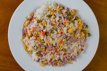 rice  with diced  ham and served withcorn, peppers  and peas