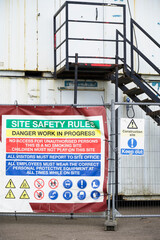 Construction site health and safety message rules sign board signage on fence boundary
