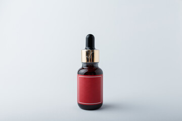 Face skin care cosmetics. Brown bottle of azelaic or hyalurone acid on white background. Mock up, no brand template, copy space