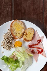 Western breakfast, toast, ham and vegetable salad