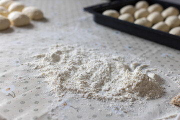Flour and dough for pies on the kitchen table. Baking at home. Selective focus.