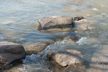 water flowing around rocks in the river