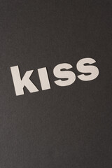 letter cut outs on paper - reads: "kiss"