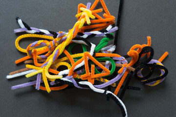 pile of abstract pipe cleaner shapes on paper
