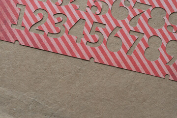 striped paper number stencil on plain brown paper 