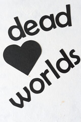 letters on paper - "dead worlds" and black paper heart