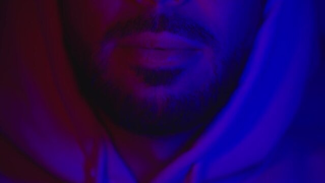 Close up of man mouth swallowing ecstasy drugs. Man taking MDMA ecstasy pill.