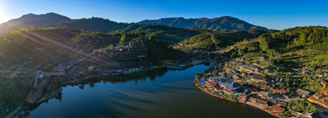 Aerial view of Sunrise with fog over Ban Rak thai, chinese village near a lake in Mae Hong Son, Thailand
