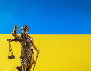 Lady Justice holding the scales on flag of Ukraine.
