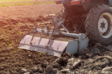 Milling mashine loosens and cultivates soil on field.