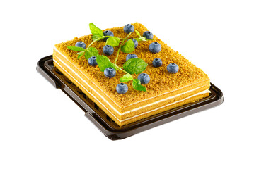 Honey cake dessert, square honey cake isolated on white background with berries