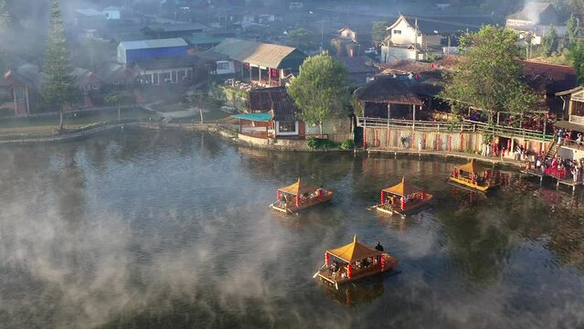 Aerial view of Sunrise with fog over Ban Rak thai, chinese village near a lake in Mae Hong Son, Thailand