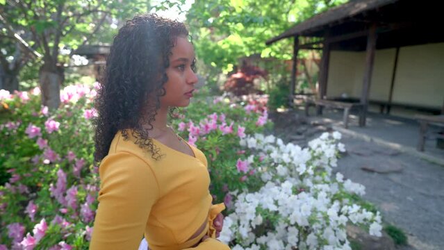 Young Woman Walking Though a Japanese Garden in Slow Motion