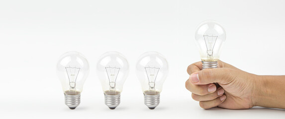 Close up hand choose light bulb or lamp on white background concepts of genius create or human resources for business leadership and creativity thinking idea or knowledge learning and innovation.