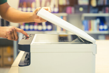 Copiers printer, Close up hand office man press copy button on panel to using the copier or photocopier machine for scanning document printing a sheet paper and xerox photocopy.