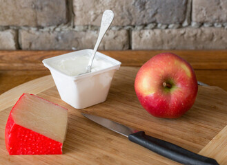 Apple and cheese on the kitchen table. Close-up. Selective focus.