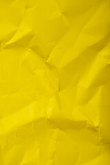 Crumpled yellow paper textured background