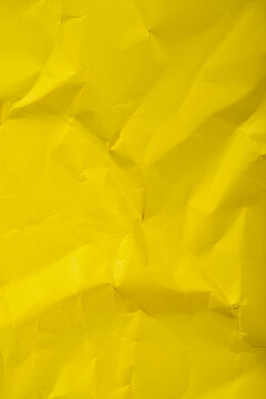 Crumpled yellow paper textured background