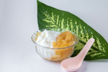 Sweet Rice Noodles with Coconut Cream in a glass cup on a white table.