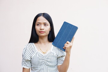 Asian woman holding a portable computer in hand