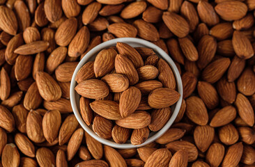 Almonds in wood bowl on wood table.Diet raw material