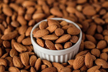 Almonds in wood bowl on wood table.Diet raw material