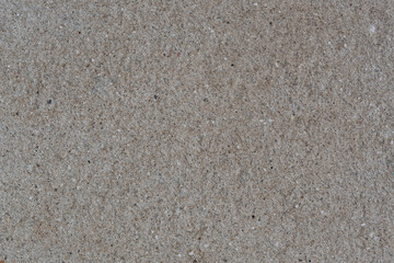 Textured wall made of fine granite chips. Light ceramic chips, with an unusual surface, are applied to the wall.