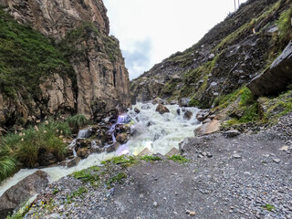 Powerful descent of the river between hills.