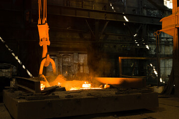 Glowing hot liqud metal in industrial foundry