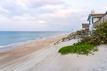 Atlantic Ocean beach in Florida. Descent on a wooden staircase to the ocean from a private house...