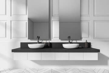 Light bathroom interior with sink and mirror, accessories on deck