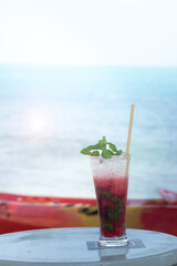 Mixed Berry Mojito with blue sea background.