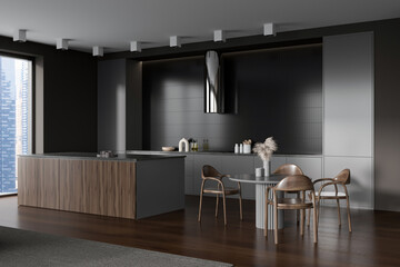 Dark kitchen interior with countertop and eating area, kitchenware and window