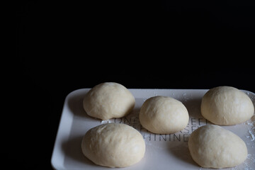 Bread before baking on a black background