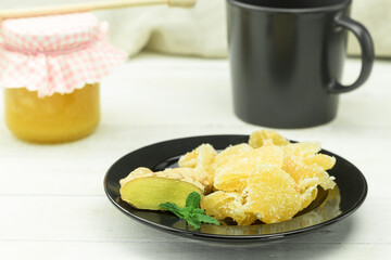 Two types of ginger - fresh and candied on a rustic table