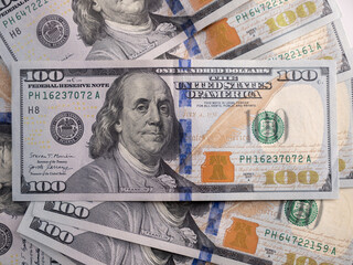 100 US dollars bills lie on the table close-up
