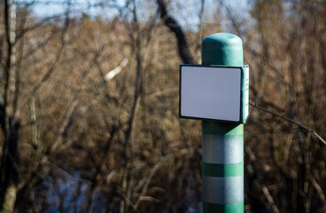 Green border post with the inscription