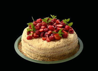 Cake on a plate with fresh raspberries