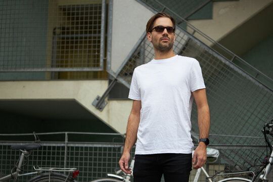 White blank t-shirt on a hipster handsome male model with space for your logo or design in casual urban style