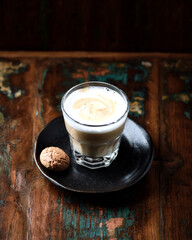 Coffee with milk on rustic wooden background. Soft focus. Close up. Copy space.