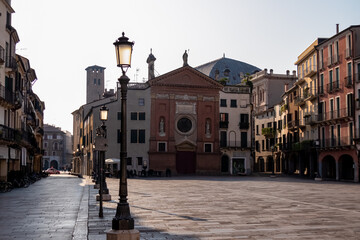 Fototapeta na wymiar Scenic view in the morning on the empty Piazza dei Signori in Padua, Veneto, Italy, Europe. The street lamps are still on, while the soft early morning light is reaching the center square in Padova