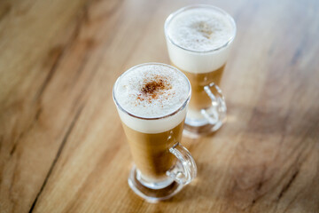 Home made coffee Cafe Macchiato on wooden table.