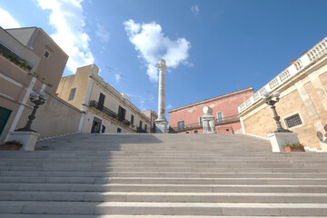 Virgiliana staircase on which the two Roman columns that indicate the end of the Appian, Brindisi, Apulia, Italy - obrazy, fototapety, plakaty